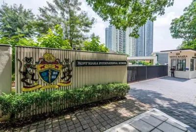 a building with a fence with a crest on it at netflix&chill Arcoris Soho 2R1B Mont Kiara in Kuala Lumpur