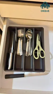 a black tray with utensils in a drawer at Neu Suites by OKBnB in Kuala Lumpur