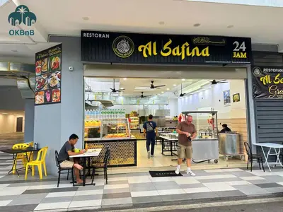 a restaurant with people sitting at tables in front of it at Neu Suites by OKBnB in Kuala Lumpur