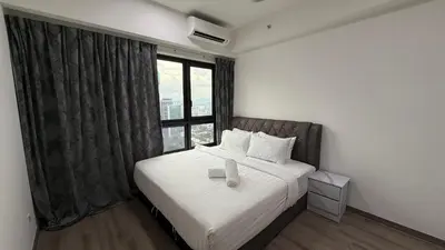 a bedroom with a bed with a large window at Agile Bukit Bintang Suits TRX Pavilion By Klcc Sky view 60 floor in Kuala Lumpur