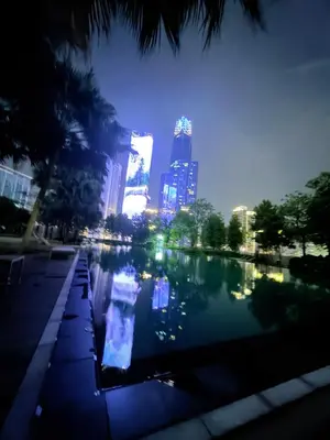 a pool of water with a city skyline at night at Agile Bukit Bintang Suits TRX Pavilion By Klcc Sky view 60 floor in Kuala Lumpur