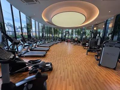 a gym with a row of treadmills and machines at Trion KL TRX KLCC 6 Pax in Kuala Lumpur