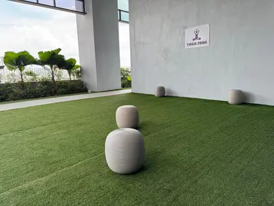 a white chair sitting on the grass in a building at Trion KL TRX KLCC 6 Pax in Kuala Lumpur