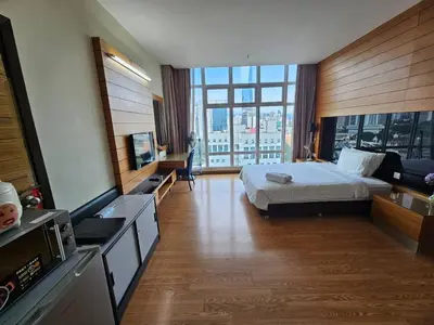 a hotel room with a bed and a large window at Expressions Suite by Rudiman in Kuala Lumpur
