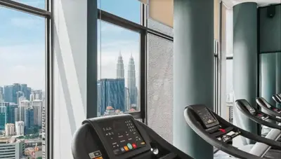 a gym with a view of a city at Expressions Suite by Rudiman in Kuala Lumpur