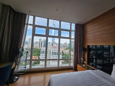 a bedroom with a large window with a city view at Expressions Suite by Rudiman in Kuala Lumpur