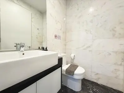 a white bathroom with a sink and a toilet at DD Royce Residence KLCC in Kuala Lumpur