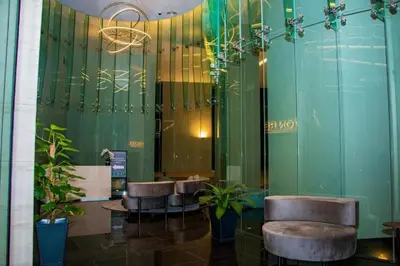 a lobby with chairs and plants in a building at \u4f0a\u987f\u9152\u5e97\u516c\u5bd3 in Kuala Lumpur