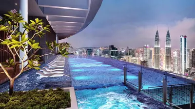 a swimming pool on top of a building with a city skyline at \u4f0a\u987f\u9152\u5e97\u516c\u5bd3 in Kuala Lumpur
