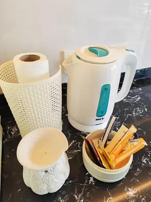 a counter top with a toaster and some utensils at Urban Designer's Duplex in Ampang