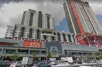 two tall buildings in a city with cars at Urban Designer's Duplex in Ampang