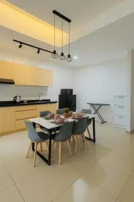 a kitchen with a dining room table and chairs at KLCC View Suites By Reizz Residence in Kuala Lumpur