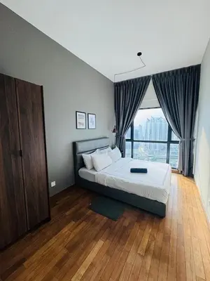 a bedroom with a bed and a large window at KLCC View Suites By Reizz Residence in Kuala Lumpur