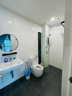 a bathroom with a shower and a toilet and a sink at KLCC View Suites By Reizz Residence in Kuala Lumpur