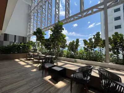 a balcony with tables and chairs on a building at The Colony By Infinitum D in Kuala Lumpur