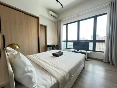 a bedroom with a white bed with a large window at The Colony By Infinitum D in Kuala Lumpur