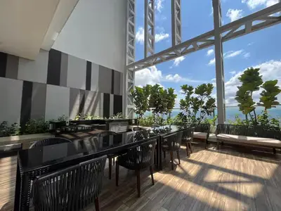 a restaurant with black chairs and a bar with a view at The Colony By Infinitum Q in Kuala Lumpur