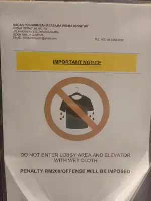a sign on the side of a bathroom stall at The Colony By Infinitum G in Kuala Lumpur