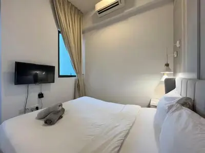 a bedroom with a white bed with a stuffed animal on it at The Colony By Infinitum R in Kuala Lumpur