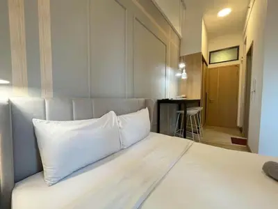 a large bed with a white pillow on top of it at The Colony By Infinitum R in Kuala Lumpur