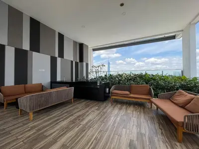a lobby with two couches and a large window at The Colony By Infinitum R in Kuala Lumpur