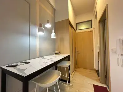 a kitchen with a counter and two stools in a room at The Colony By Infinitum R in Kuala Lumpur