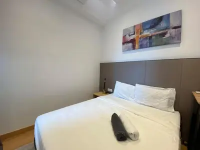 a pair of shoes sitting on top of a bed at The Colony By Infinitum T in Kuala Lumpur