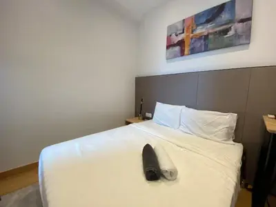a pair of shoes sitting on top of a bed at The Colony By Infinitum T in Kuala Lumpur