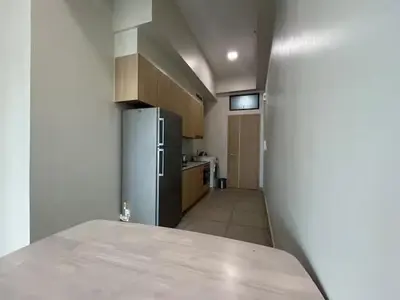 a kitchen with a refrigerator and a counter top at The Colony By Infinitum F in Kuala Lumpur