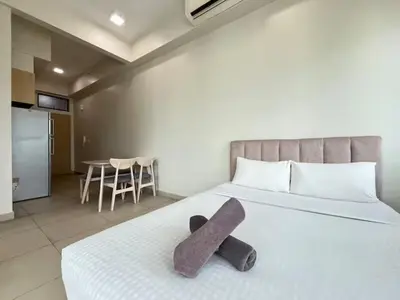 a stuffed animal laying on a bed in a room at The Colony By Infinitum F in Kuala Lumpur