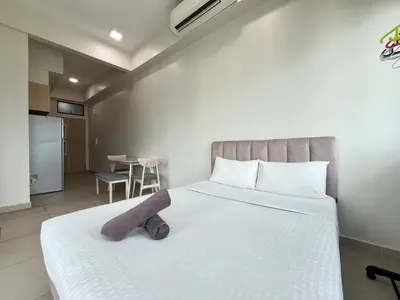a bed with a stuffed animal sitting on top of it at The Colony By Infinitum F in Kuala Lumpur
