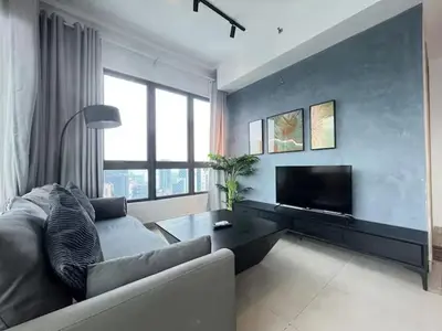 a living room with a couch and a flat screen tv at The Colony By Infinitum N in Kuala Lumpur