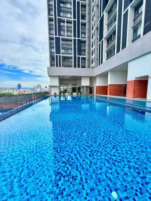 a large swimming pool in a building with tall buildings at Chambers Suites Mrk in Kuala Lumpur