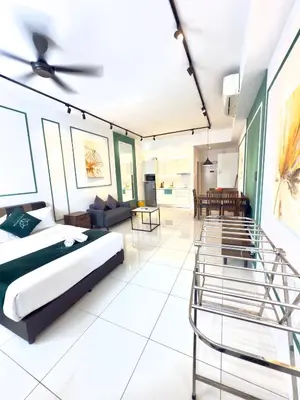 a bedroom with a bed and a living room at Chambers Suites Mrk in Kuala Lumpur
