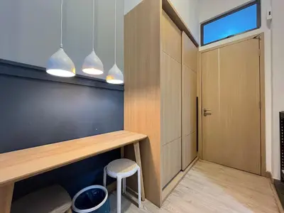 a room with a desk and a door and a stool at The Colony By Infinitum K in Kuala Lumpur