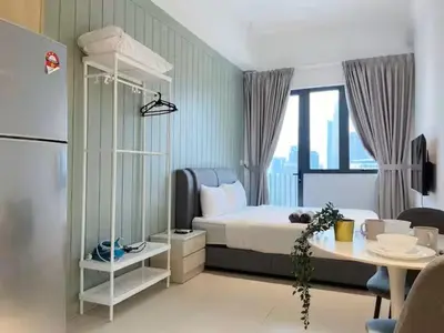 a bedroom with a bed and a desk and a table at The Colony By Infinitum E in Kuala Lumpur