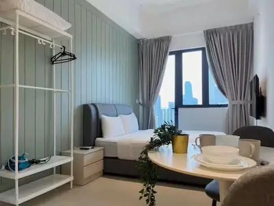 a bedroom with a bed and a table in a room at The Colony By Infinitum E in Kuala Lumpur