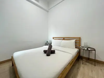 a teddy bear sitting on top of a bed at The Colony By Infinitum H in Kuala Lumpur