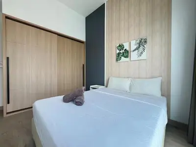 a bedroom with two beds with a stuffed animal on top at The Colony By Infinitum C in Kuala Lumpur