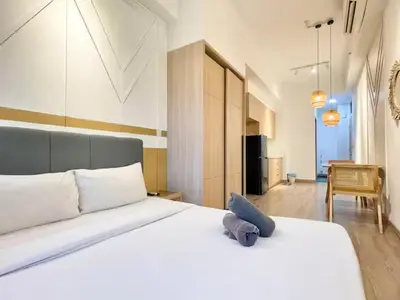 a bedroom with a large white bed with a blue pillow at The Colony By Infinitum A in Kuala Lumpur