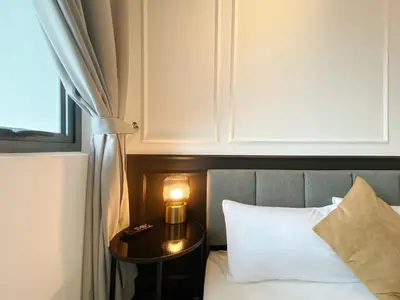a bedroom with a bed with a table and a cupboard at The Colony By Infinitum S in Kuala Lumpur