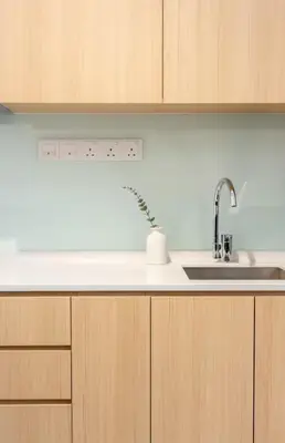 a kitchen with a sink and wooden cabinets at The Colony By Infinitum S in Kuala Lumpur