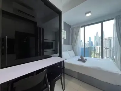 a hotel room with a bed and a large window at The Colony By Infinitum M in Kuala Lumpur