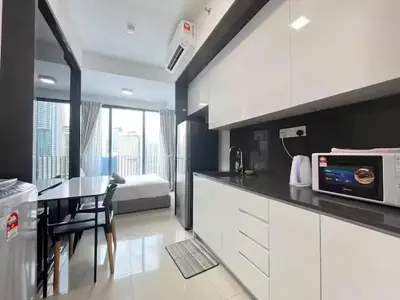 a kitchen with a dining table and a microwave at The Colony By Infinitum M in Kuala Lumpur