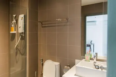 a bathroom with a toilet and a sink and a shower at Mercu Summer Suites Bernice KLCC in Kuala Lumpur