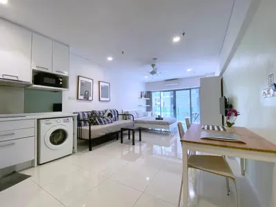 a kitchen and living room with a washing machine at Mercu Summer Suites Bernice KLCC in Kuala Lumpur