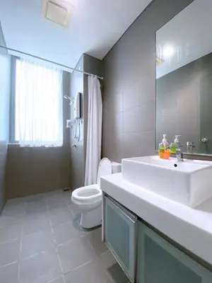 a bathroom with a white sink and a toilet at Mercu Summer Suites Bernice KLCC in Kuala Lumpur