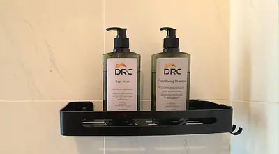 two shampoo bottles sitting on a shelf on a wall at New 5 min Gleneagles Hospital 10 min KLCC in Kuala Lumpur