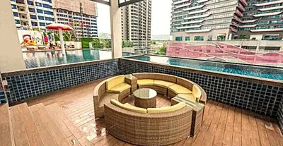 a building with a pool and a bench in front of a building at New 5 min Gleneagles Hospital 10 min KLCC in Kuala Lumpur