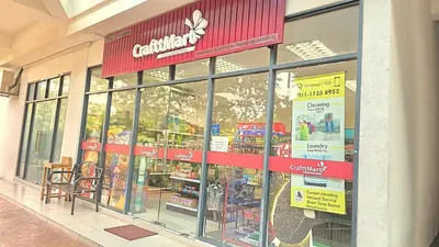 a store front of a grocery store with a red sign at New 5 min Gleneagles Hospital 10 min KLCC in Kuala Lumpur